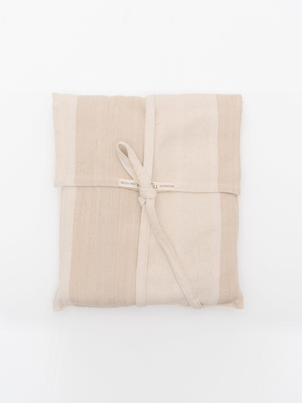 A striped peach and pink cotton throw blanket with fringes and a matching pouch, displayed neatly folded.