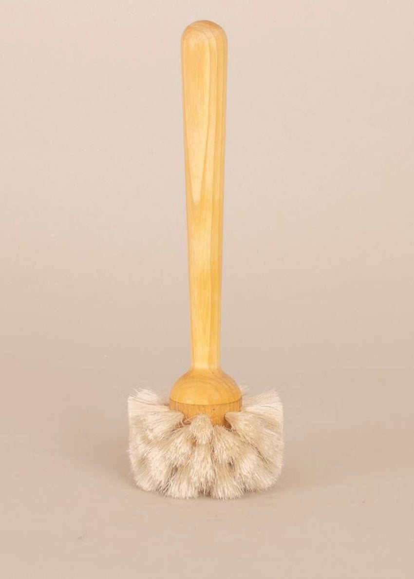 Wooden scrub brush with bristle head on a beige background