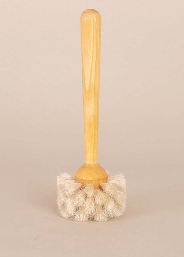 Wooden scrub brush with bristle head on a beige background