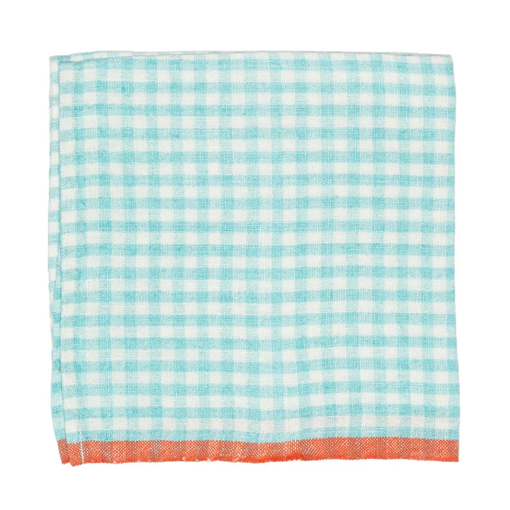 A square napkin with a light blue gingham check pattern and a solid orange-red fringed border.