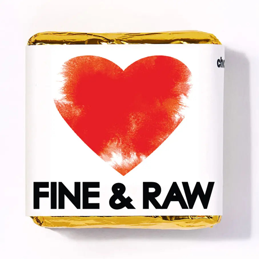 Bar of chocolate with a red heart and 'Fine & Raw' text on a white background