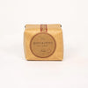 A square kraft paper package of JQ Dickinson Salt Works salt, featuring a large circular brown label on the front, set against a plain white background.