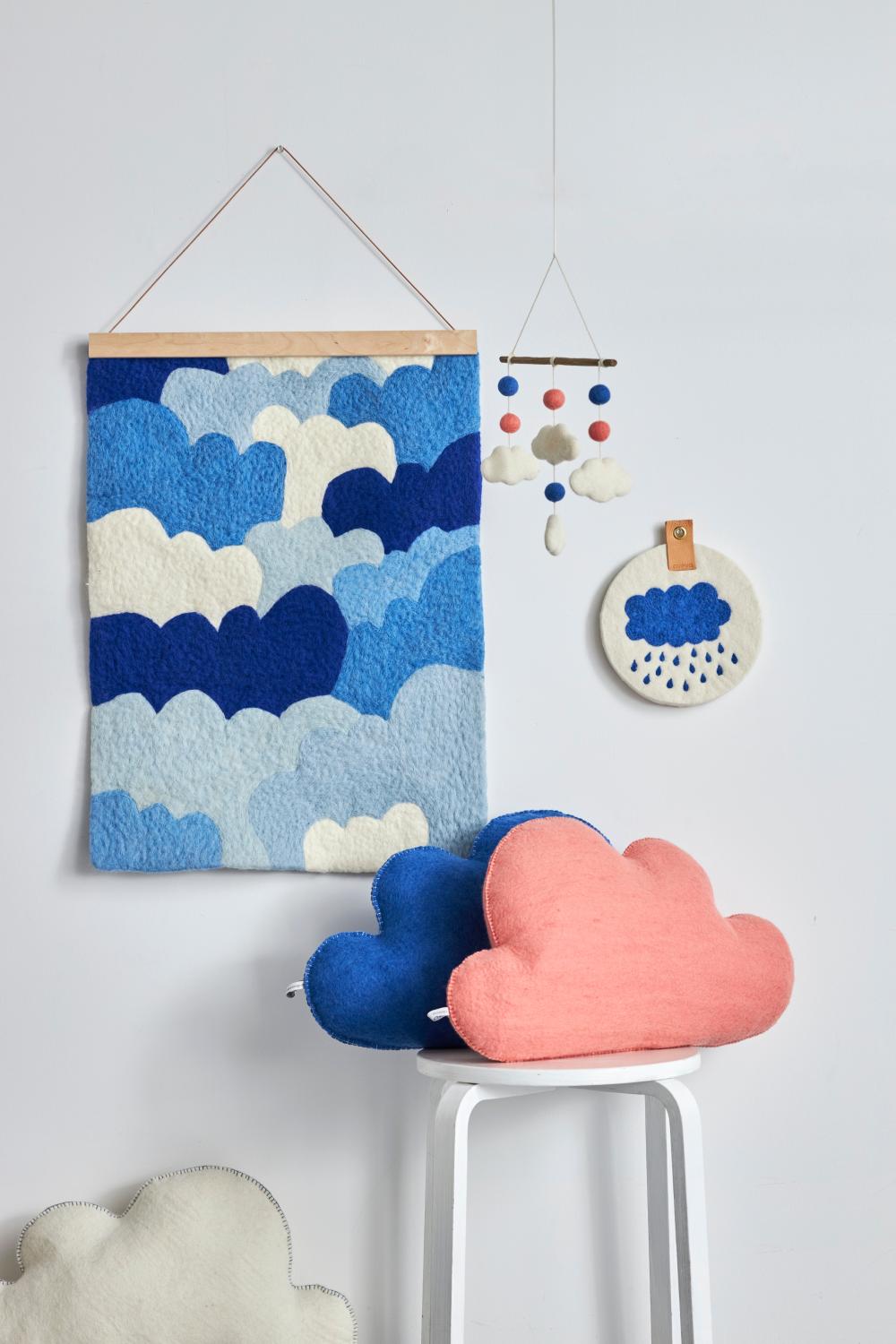 White, blue and pink, cloud-shaped cushions.