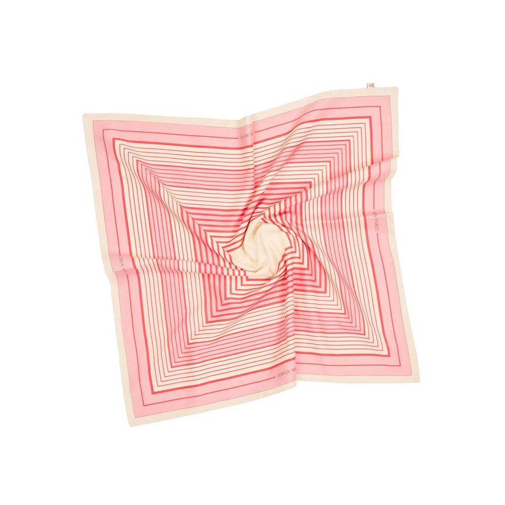 A scarf with a geometric stripe pattern in rose pink, cherry red, and clotted cream colors, displaying the Lorna Murray brand name.