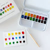 Watercolor paint set with color swatches on a white surface