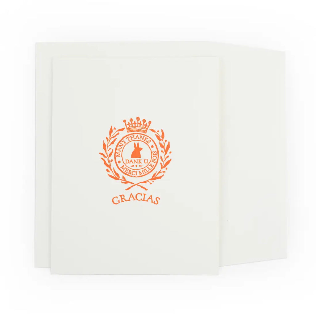 White card with orange emblem and 'GRACIAS' text on a white background