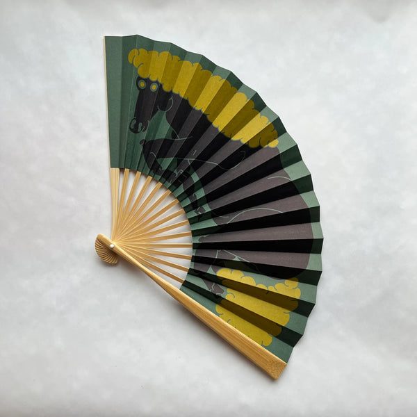 Handheld fan with a horse design on a white background