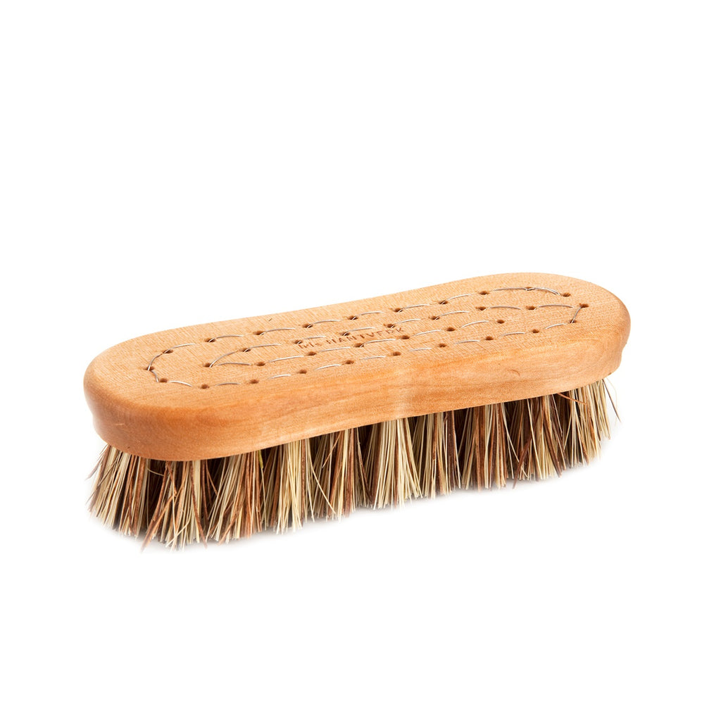 Wooden brush with bristles on a white background