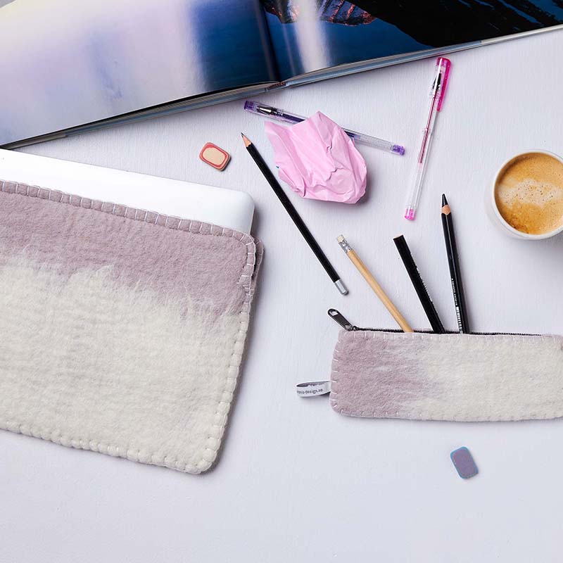 Desk with stationery items including pens, pencils, and a cup of coffee on a white surface.