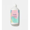 Bottle of 'Petit Grain' Kerzon laundry detergent on a light gray background