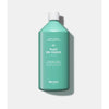 Green bottle of Kerzon Place Des Vosges laundry soap on a white background