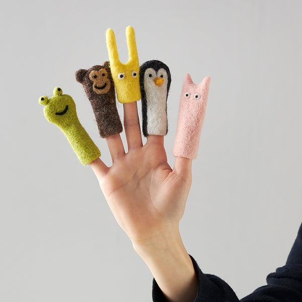 A hand wearing five finger puppets in various colors and animal shapes, including a bear, a rabbit, an owl, a penguin, and a sheep.