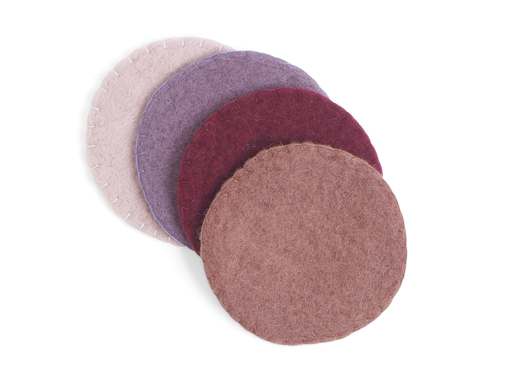 Handmade wool coasters in various shades of lavender.