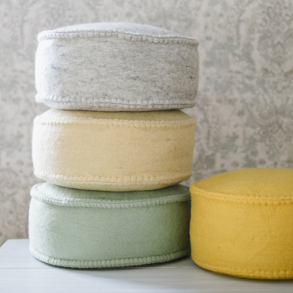 A collection of round floor dots in various colors, arranged in a stacked formation.