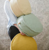 A person holding a collection of round floor dots in various colors.