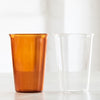 Two large drinking glasses, one amber and one clear glass.